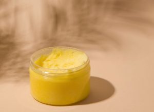 Cosmetics. Face and body scrub in a jar on a beige background. Copy space